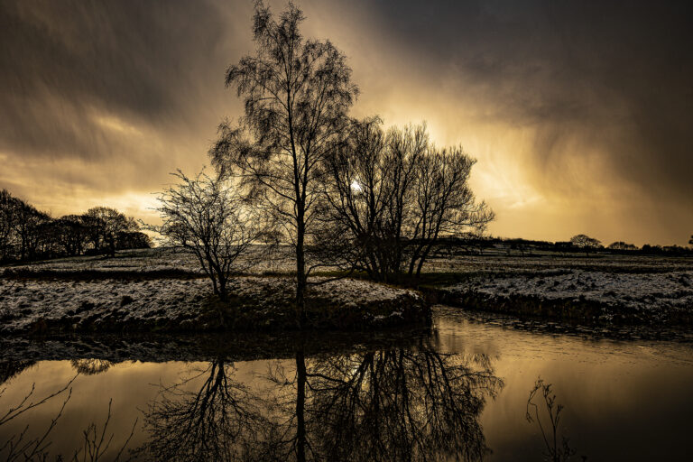 The Leeds Liverpool Canal frozen mid winter. The frozen water has it’s own unusual surface and reflections.