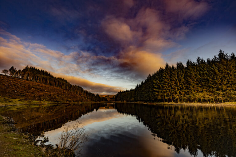 A freezing cold dawn at Entwistle Reservoir. The sky changes colour rapidly as the sunlight comes over the hills. From peaceful and calm to moody and dramatic in minutes.