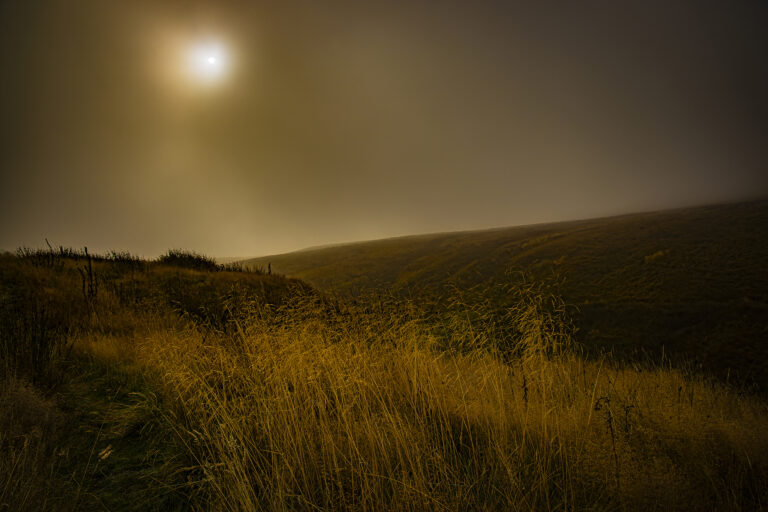 Heavy mist drifting over the hills in Rivington.  As the sun rises the mist becomes coloured and casts a warm glow over the landscape.