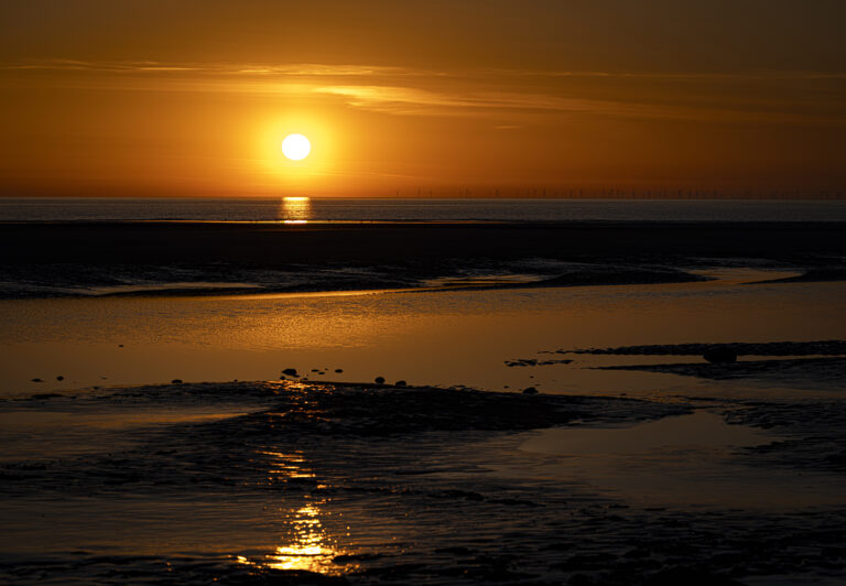 A glorious sunset in Blackpool with the tide out.  The wind farms are visible aswell as The Isle of Man in the distance.