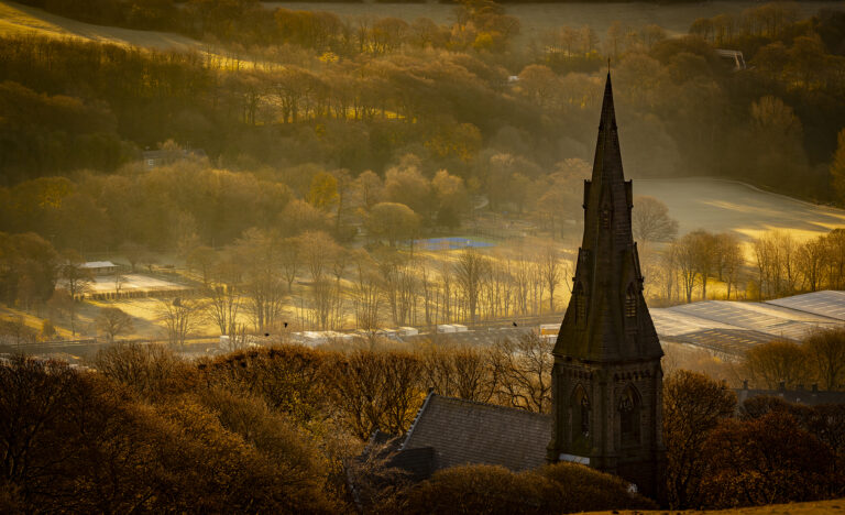 Holcombe Hill on a very cold winter morning.  The last remains of mist vanishes as warm light covers the hills over Rossendale.