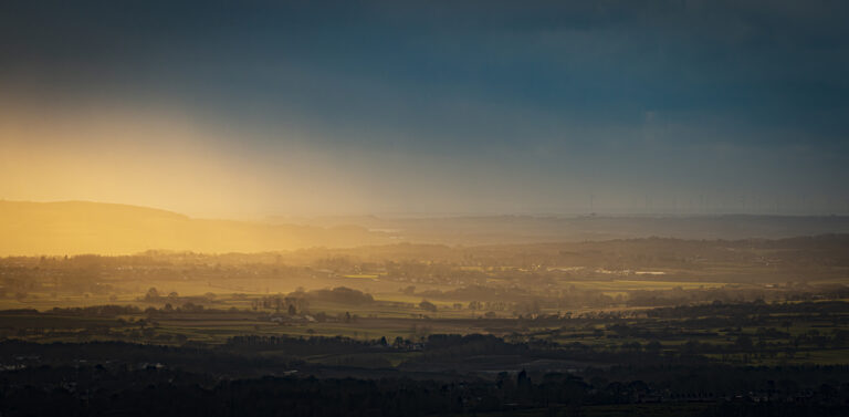 Dramatic sunlight over Rivington and the Pennine Moors.  Heavy clouds roll in over the hills with the sun creating some stunning lighting for a few minutes.