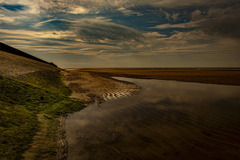Dramatic clouds on a typical autumn day on Blackpool beach.  High fast moving clouds overhead create striking high contrast shapes and textures.  Deserted because of the threat of rain which arrived quickly.